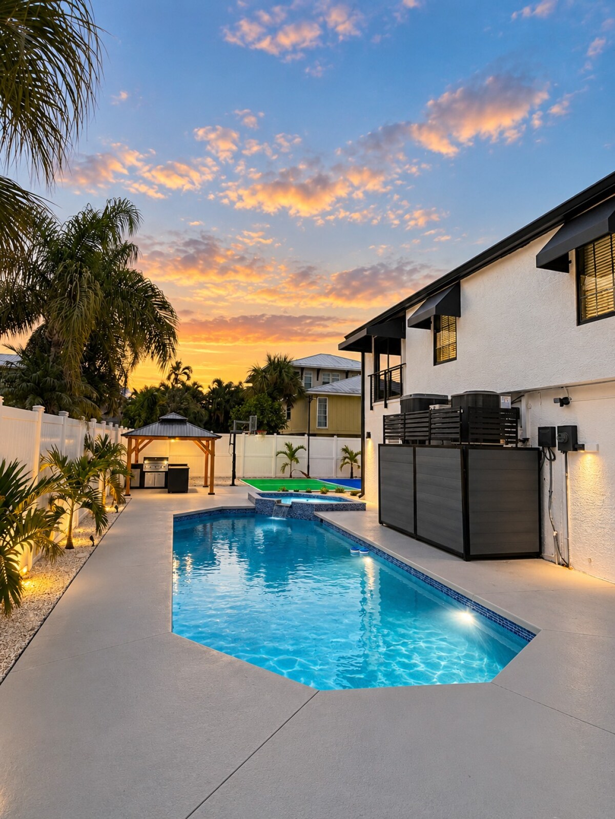 Sunset settles over the heated pool and coconut palms